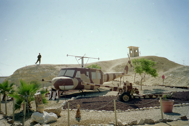 Soldier on hill over helicopter