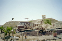 Soldier on hill over helicopter