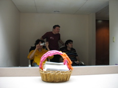 Nathan, Gabe, and Phil in the rocking chairs in the anteroom of the girls' restroom