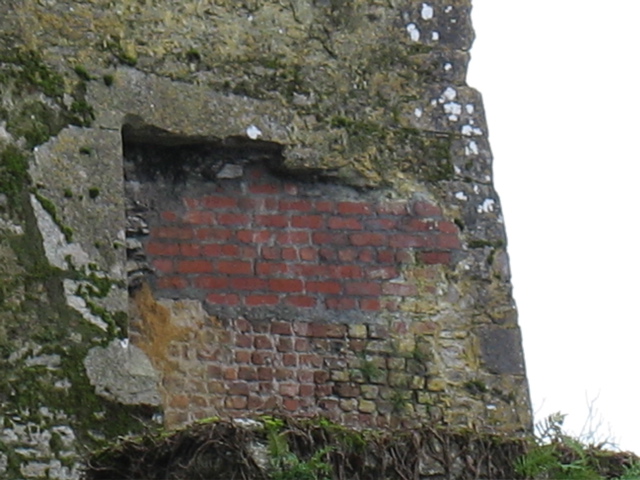 Random unexplained patch of red brick that does not fit the pattern of the castle.