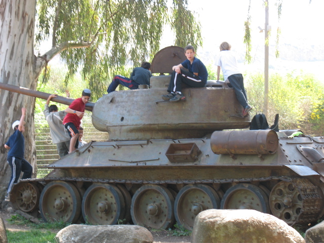 Israeli kids play on a tank.