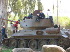 Israeli kids play on a tank.