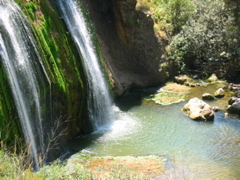 The waterfall cascades into the pool