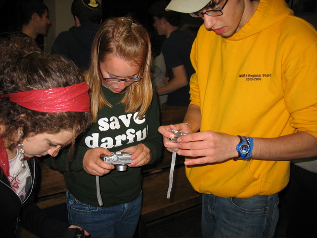 Amy, Rachel, Aaron, taking pictures of shoes